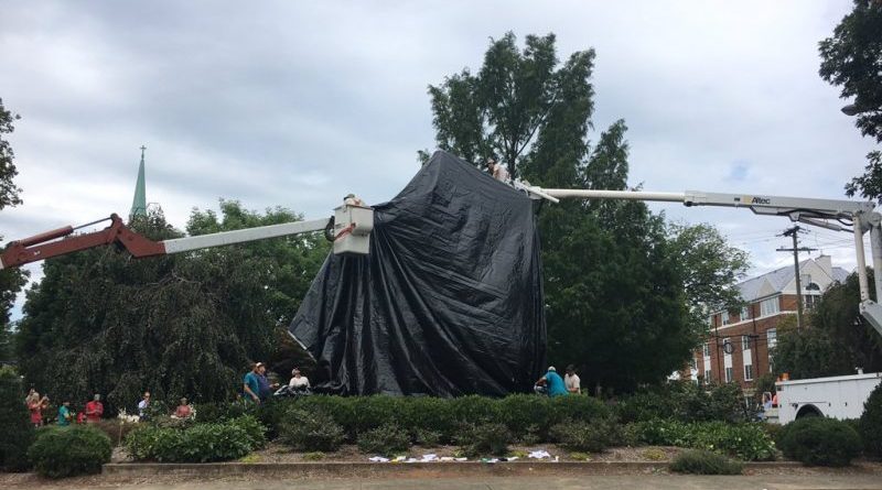 A monument to General Lee in Charlottesville hid under a black tarpaulin