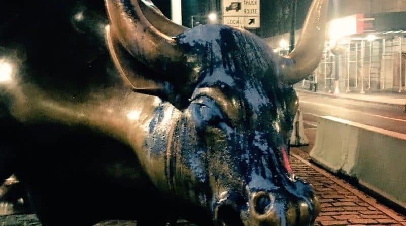 The sculpture of the bull on wall street was doused with blue paint
