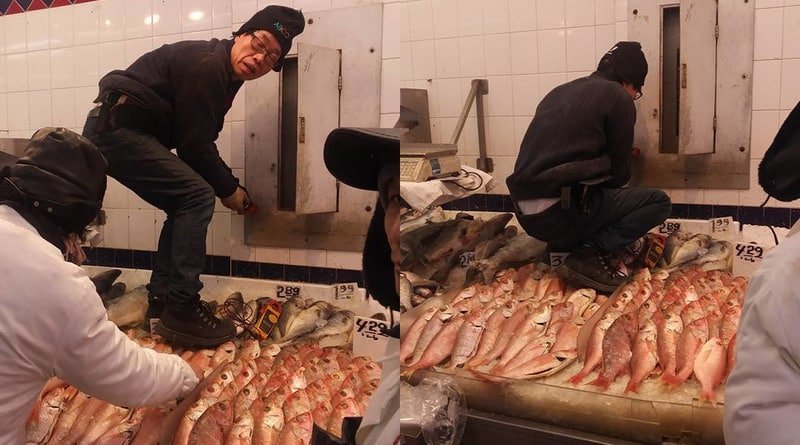 In Chinatown in new York a worker was marking the fish, lying on the counter