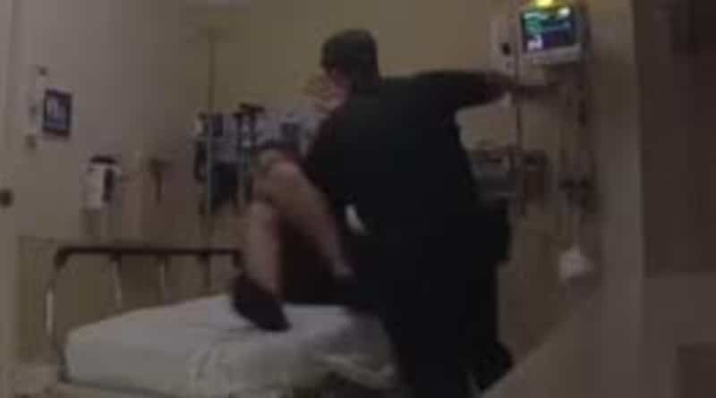 A police officer beat and twisted hands with a man, confined to a hospital bed